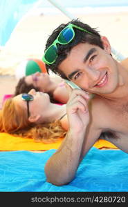 Young man using a cellphone on the beach
