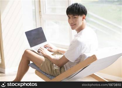 Young man using a laptop at home