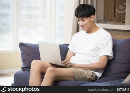 Young man using a laptop at home