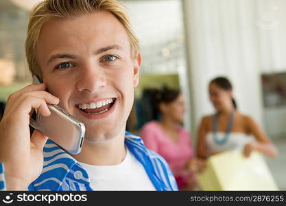 Young Man Using Cell Phone in Store