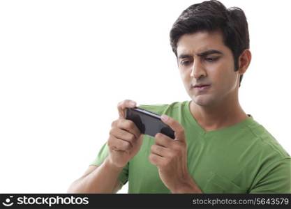 Young man using cell phone over white background