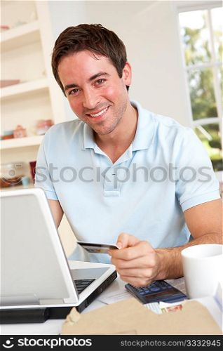 Young man using credit card on the internet