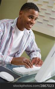 Young Man Using Desktop Computer