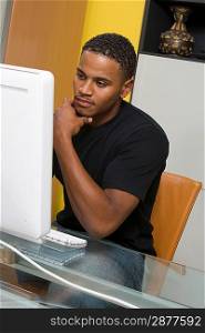 Young Man Using Desktop Computer