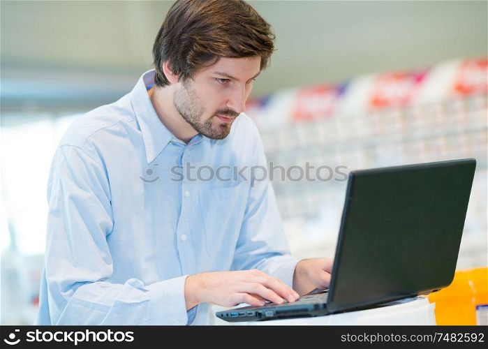 young man using laptop in workplace