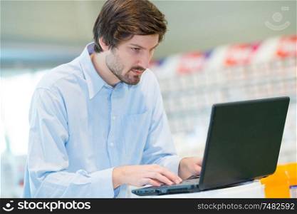 young man using laptop in workplace