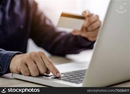 young man using mobile phone for online payments/ shopping online