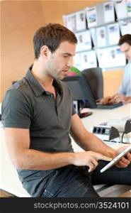 Young man using tablet in office