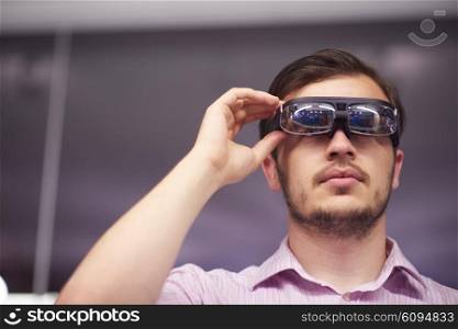 young man using virtual reality gadget computer technology glasses
