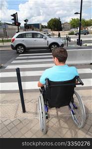 Young man using wheelchair in town