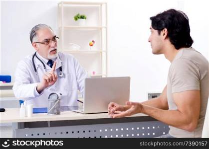 Young man visiting old male doctor  . Young man visiting old male doctor 