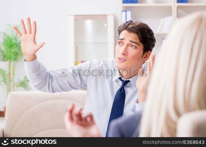 Young man visiting psychiatrist doctor for consultation