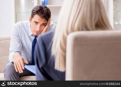 Young man visiting psychiatrist doctor for consultation