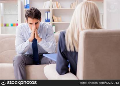 Young man visiting psychiatrist doctor for consultation