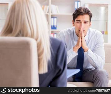 Young man visiting psychiatrist doctor for consultation. The young man visiting psychiatrist doctor for consultation