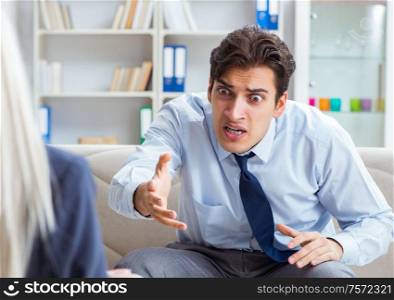 Young man visiting psychiatrist doctor for consultation. The young man visiting psychiatrist doctor for consultation