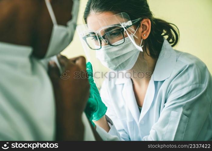 Young man visits skillful doctor at hospital for vaccination . Covid 19 and coronavirus vaccination center service concept .. Young man visits skillful doctor at hospital for vaccination