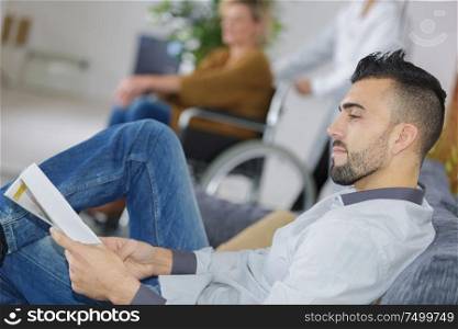 young man waiting for the doctor in hospital lobby
