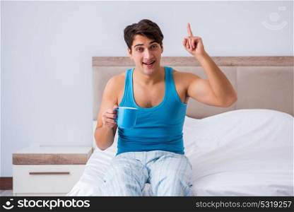 Young man waking up in bed