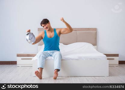 Young man waking up in bed