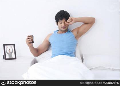 Young man waking up in morning