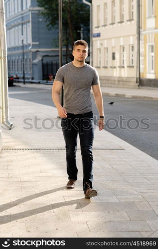 Young man walking at the street