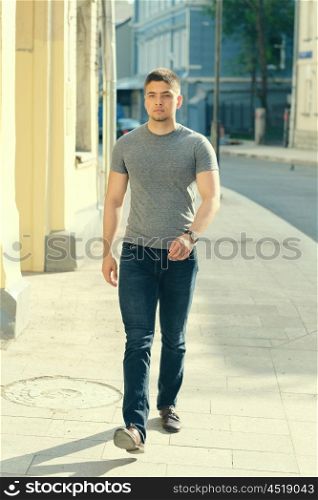 Young man walking at the street