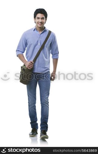Young man walking over white background
