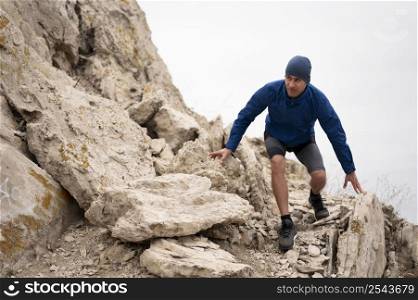 young man walking through rocks nature