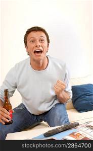 Young Man Watching Television and Cheering