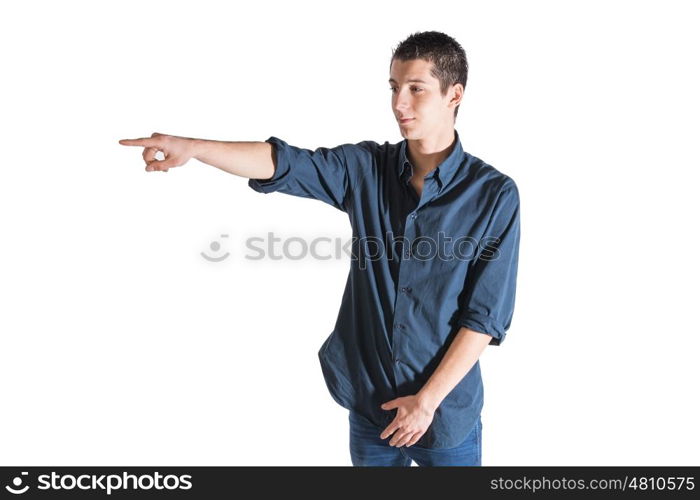 young man wearing blue shirt pointing against white background