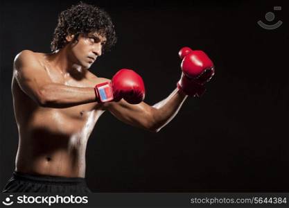 Young man wearing boxing gloves