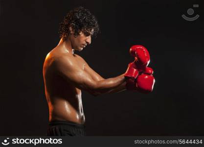 Young man wearing boxing gloves
