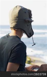 Young man wearing hat, back view