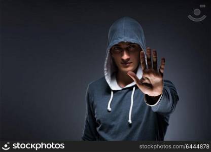 Young man wearing hoodie pressing virtual buttons