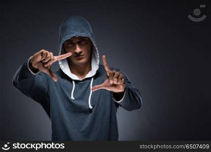 Young man wearing hoodie pressing virtual buttons
