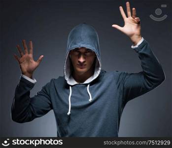 Young man wearing hoodie pressing virtual buttons. The young man wearing hoodie pressing virtual buttons