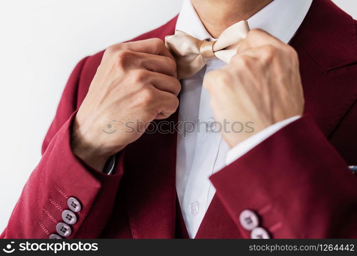 Young man wearing red suit with bow tie