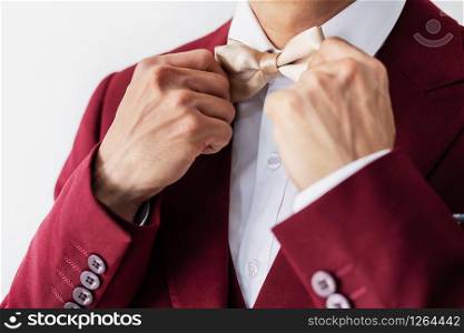 Young man wearing red suit with bow tie