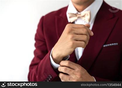 Young man wearing red suit with bow tie