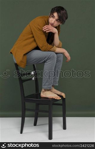 young man wearing shirt posing chair 4