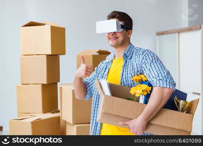 Young man wearing VR glasses moving in new apartment