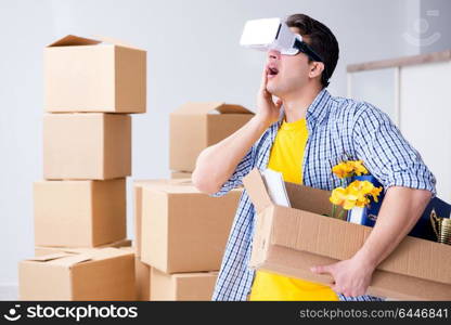 Young man wearing VR glasses moving in new apartment