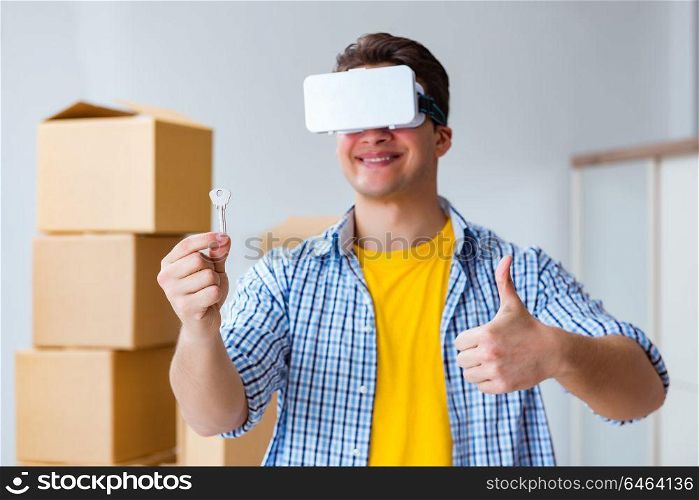 Young man wearing VR glasses moving in new apartment