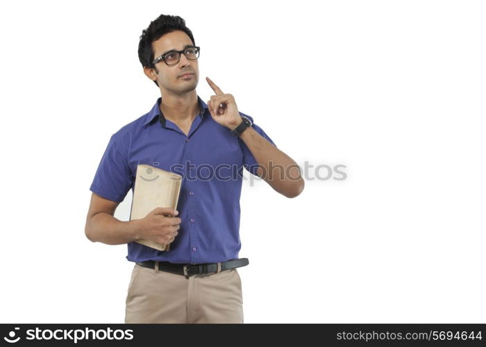 Young man with a book thinking