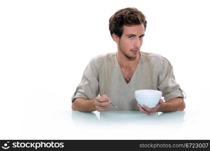 Young man with a breakfast bowl