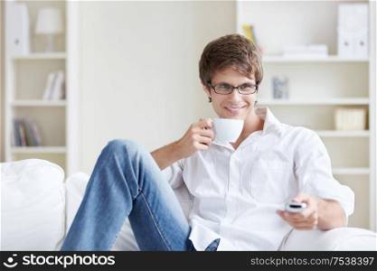 Young man with a cup at home