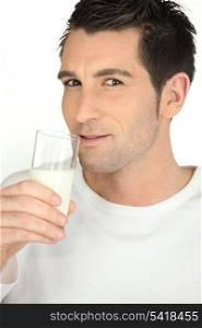 Young man with a glass of milk