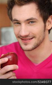 Young man with a red apple