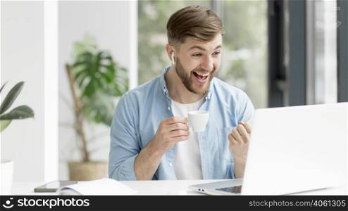young man with airpods working laptop